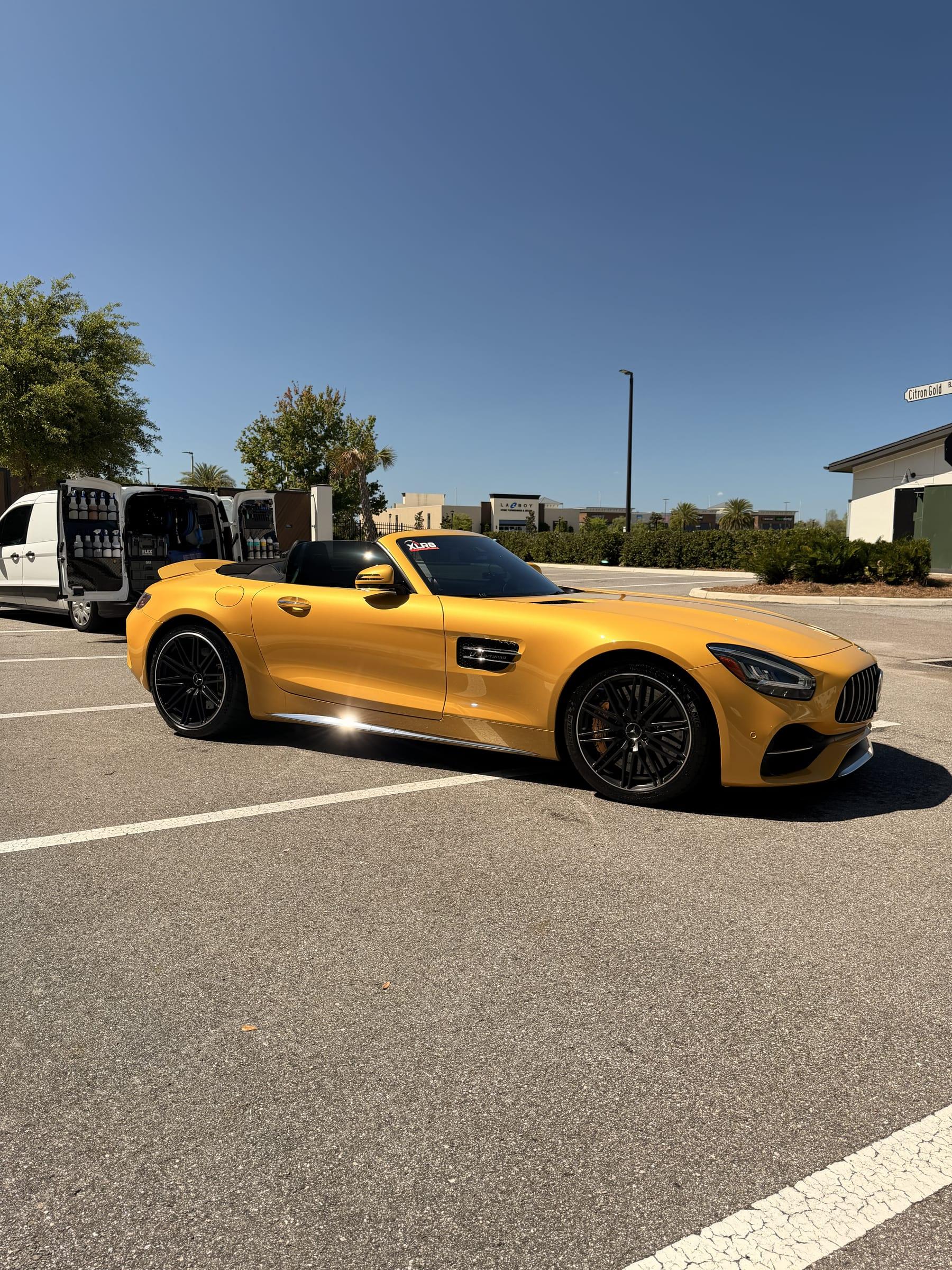 Finished yellow Mercedes-AMG GT C Roadster beside the Coastal Prestige Detailing van after an inside and out detail