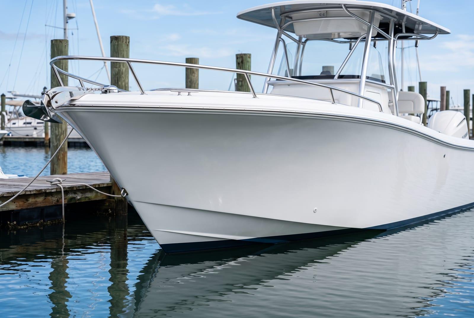 A freshly detailed white boat hull at a Tampa Bay dock