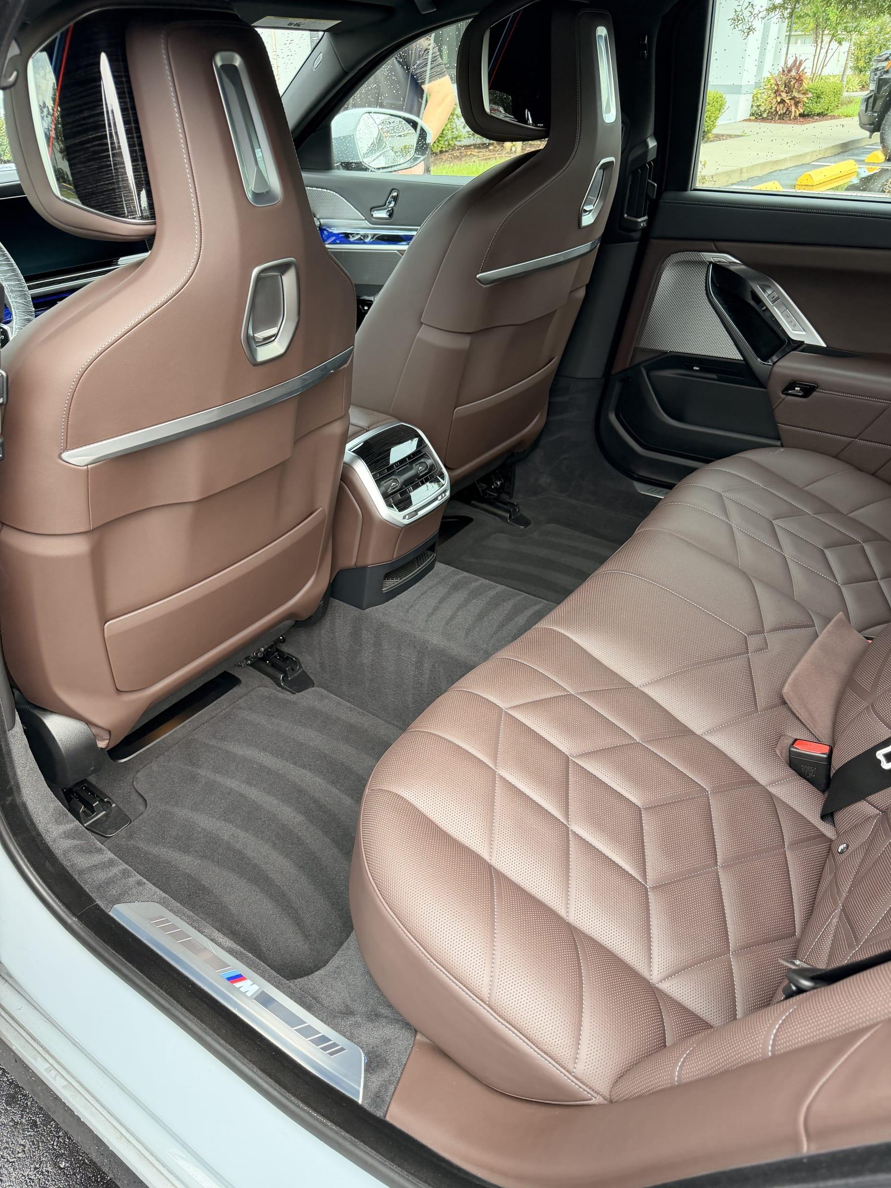 Quilted tobacco leather rear seats of a BMW after an interior detail, leather cleaned and conditioned