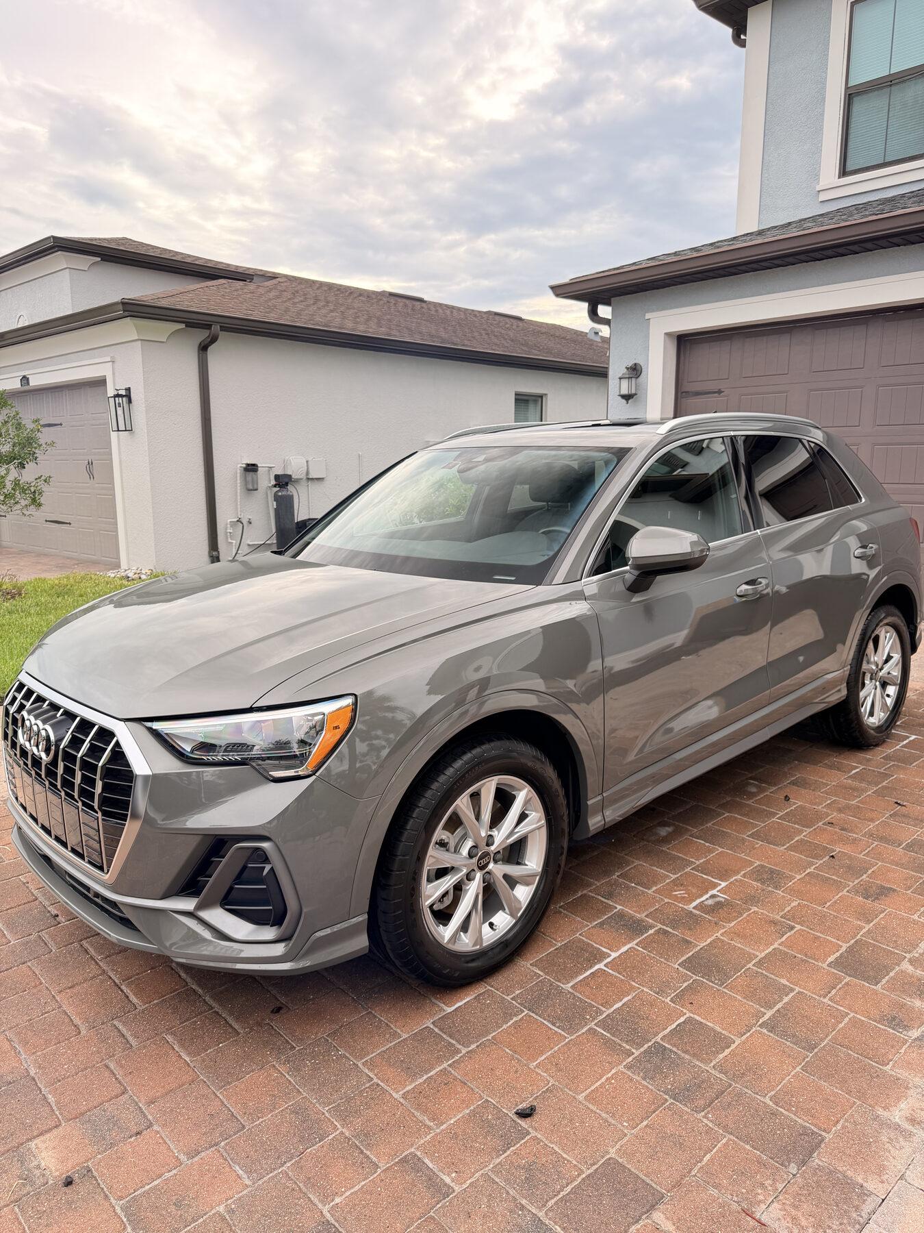 Finished Audi Q3 in grey on a paver driveway in Wesley Chapel after paint correction and ceramic coating