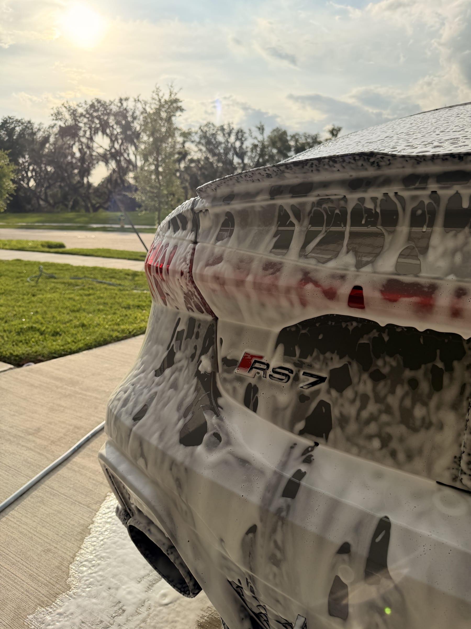 Audi RS7 covered in foam during a hand wash on a driveway in Tampa Bay